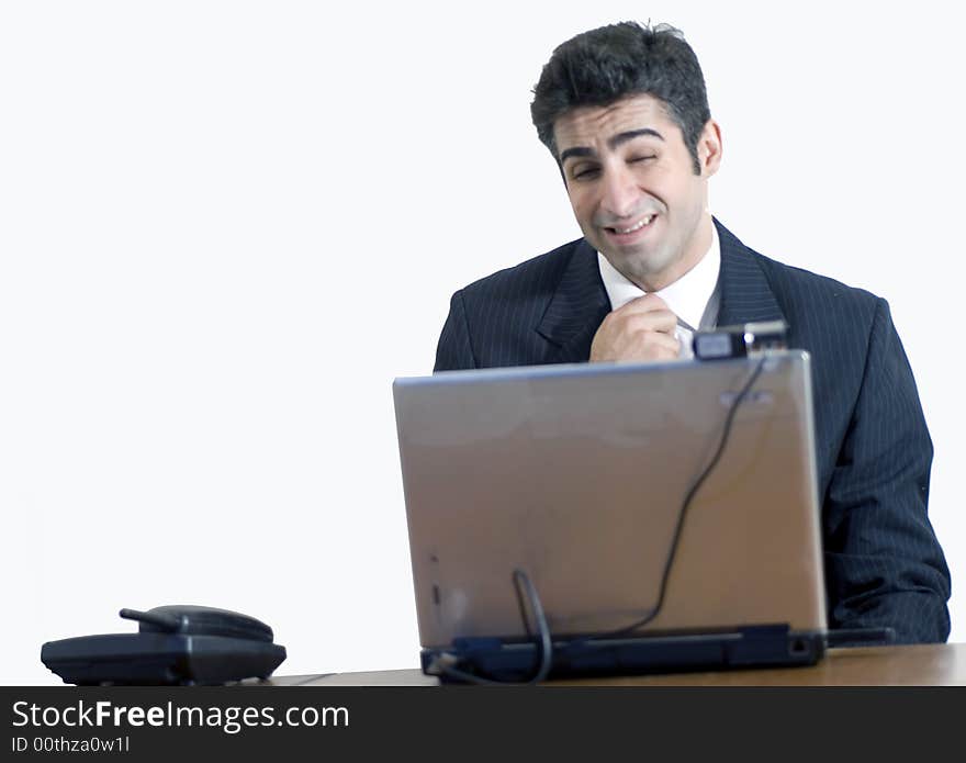 Tired businessman at his laptop. Isolated against a white background. Tired businessman at his laptop. Isolated against a white background