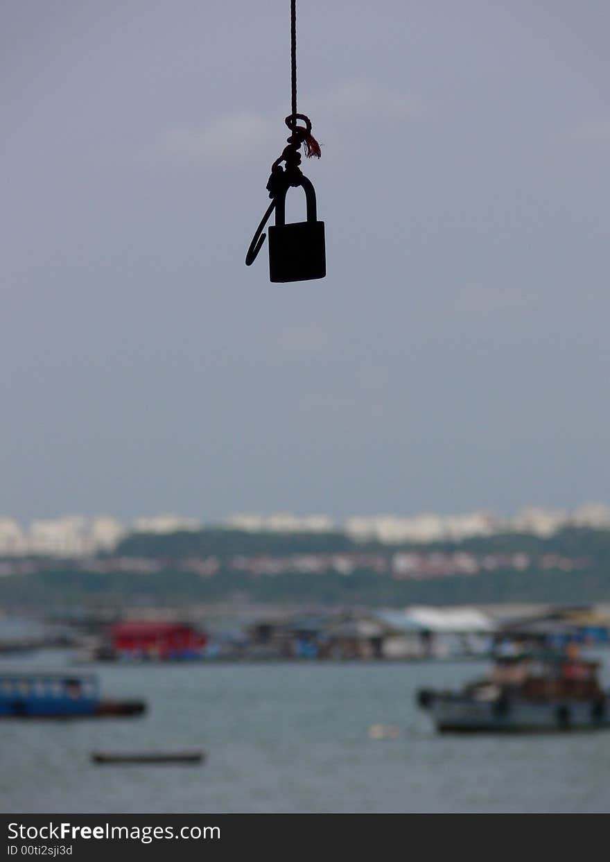 Lock hanging from tree.  Looks like you need a key to enter into the travel world. Lock hanging from tree.  Looks like you need a key to enter into the travel world.