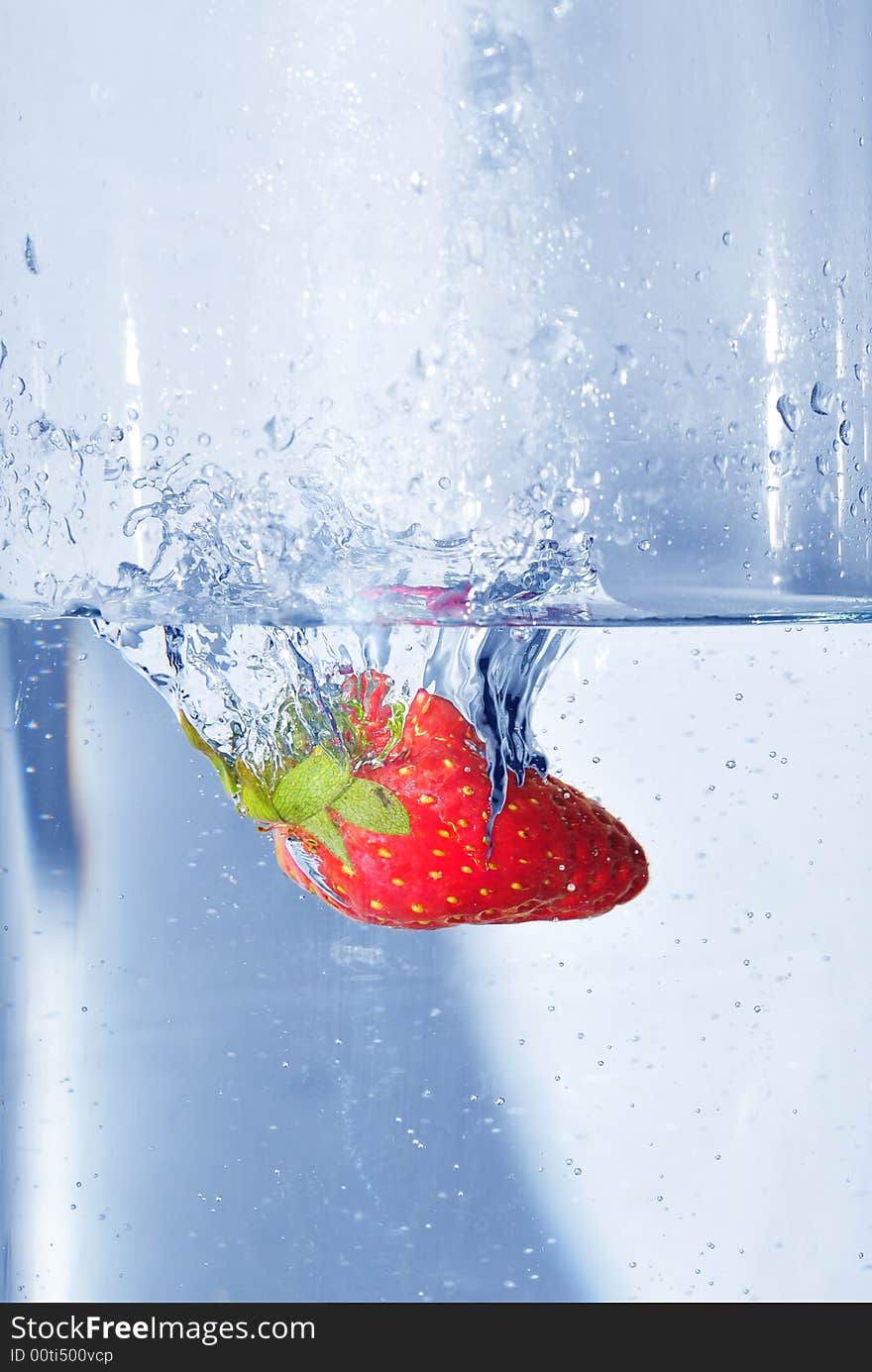 Splashing strawberry into a water. Splashing strawberry into a water