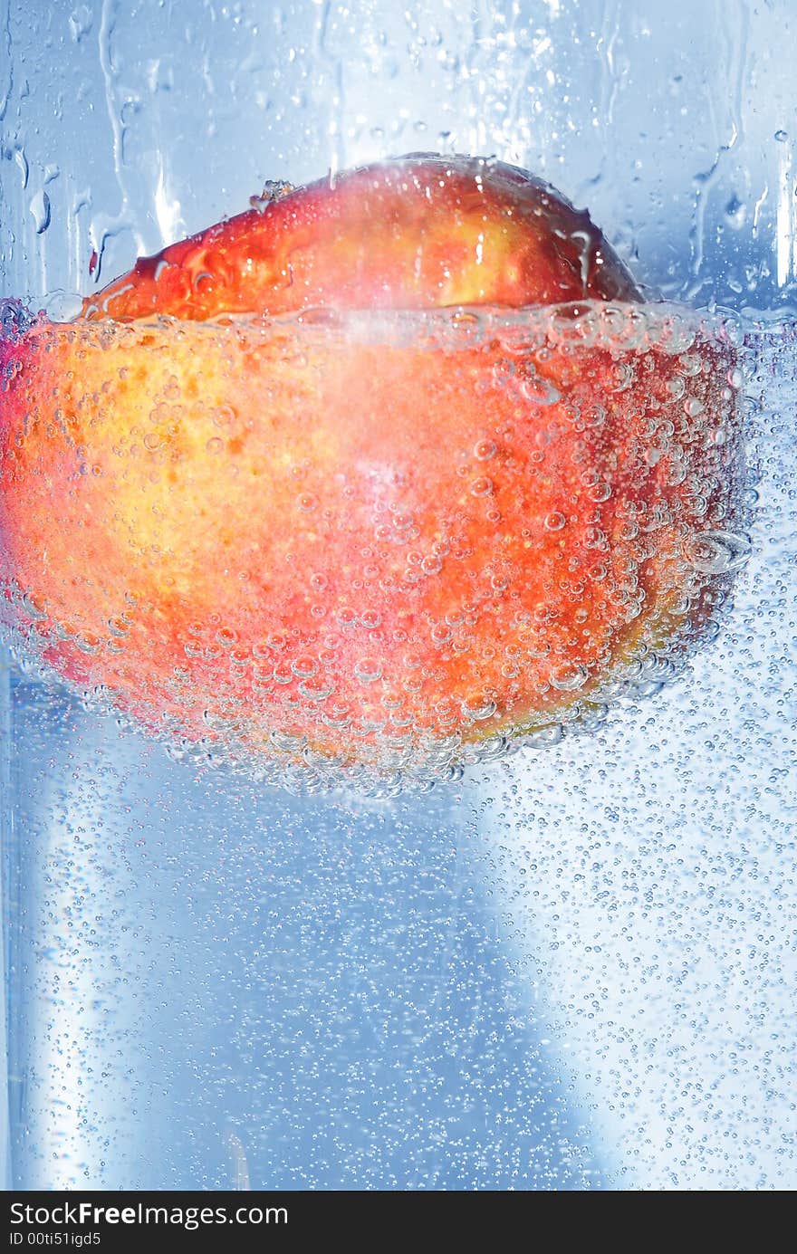 Splashing apple into a water