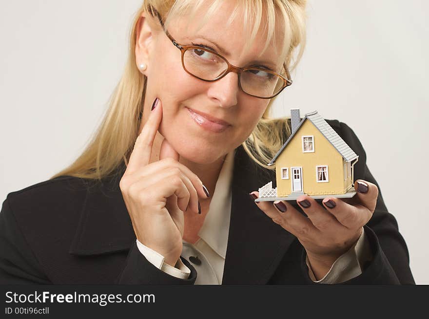 Female holding small house - making a decision. Female holding small house - making a decision.