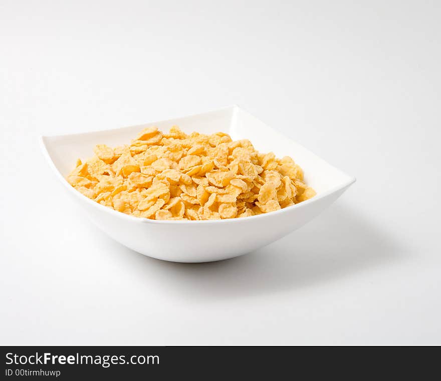 Bowl of flakes on white