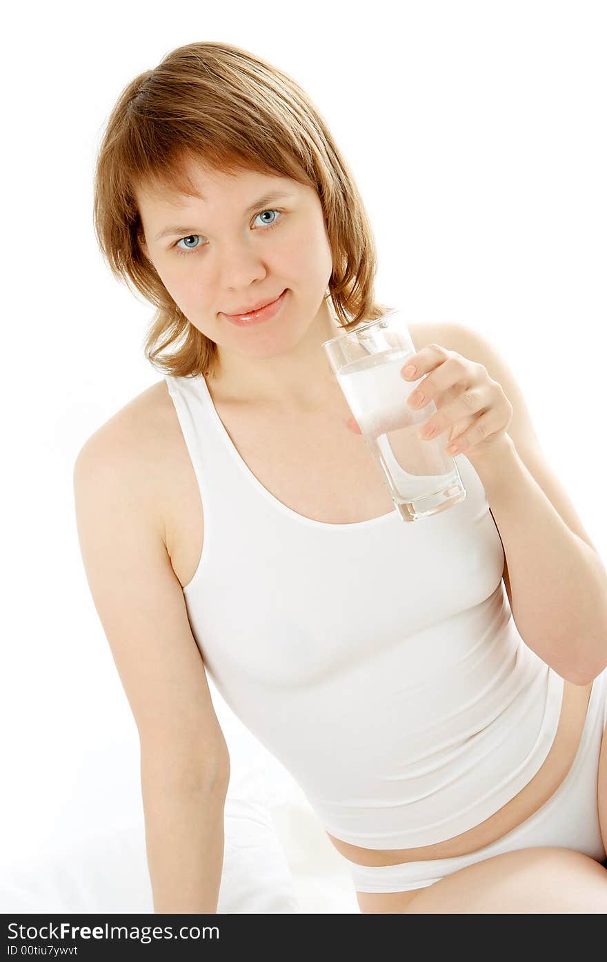 Woman in bed with white lingerie and water glass