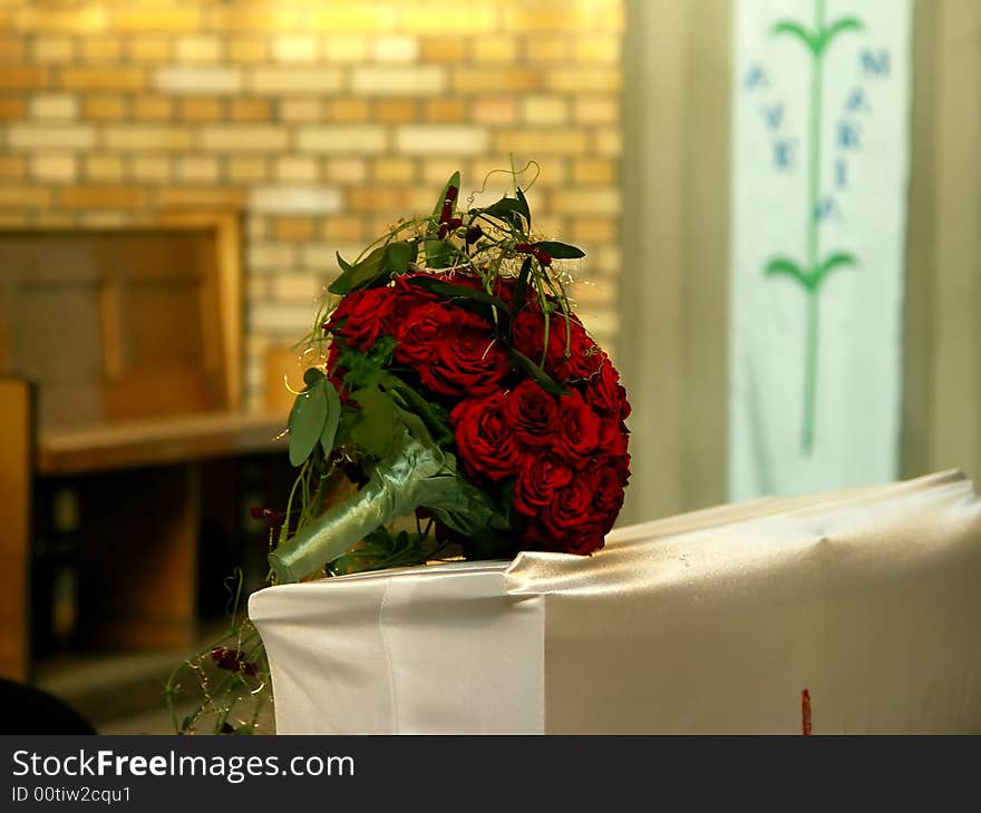 Wedding bouquet from red roses at the church