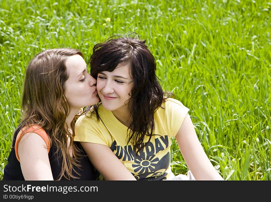 Friendly kiss betwen two young women. Friendly kiss betwen two young women