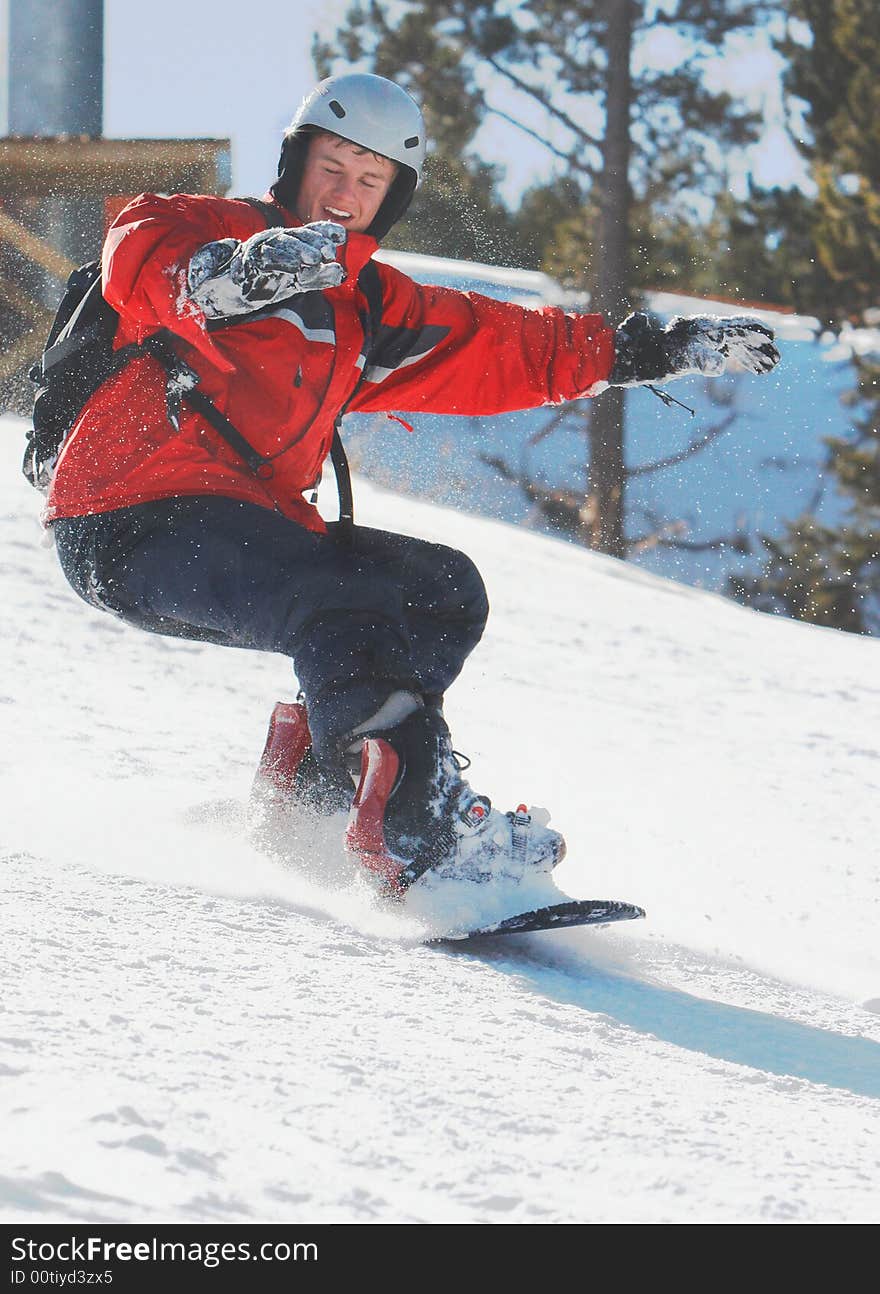 Boy skiboarding in bright sunligt