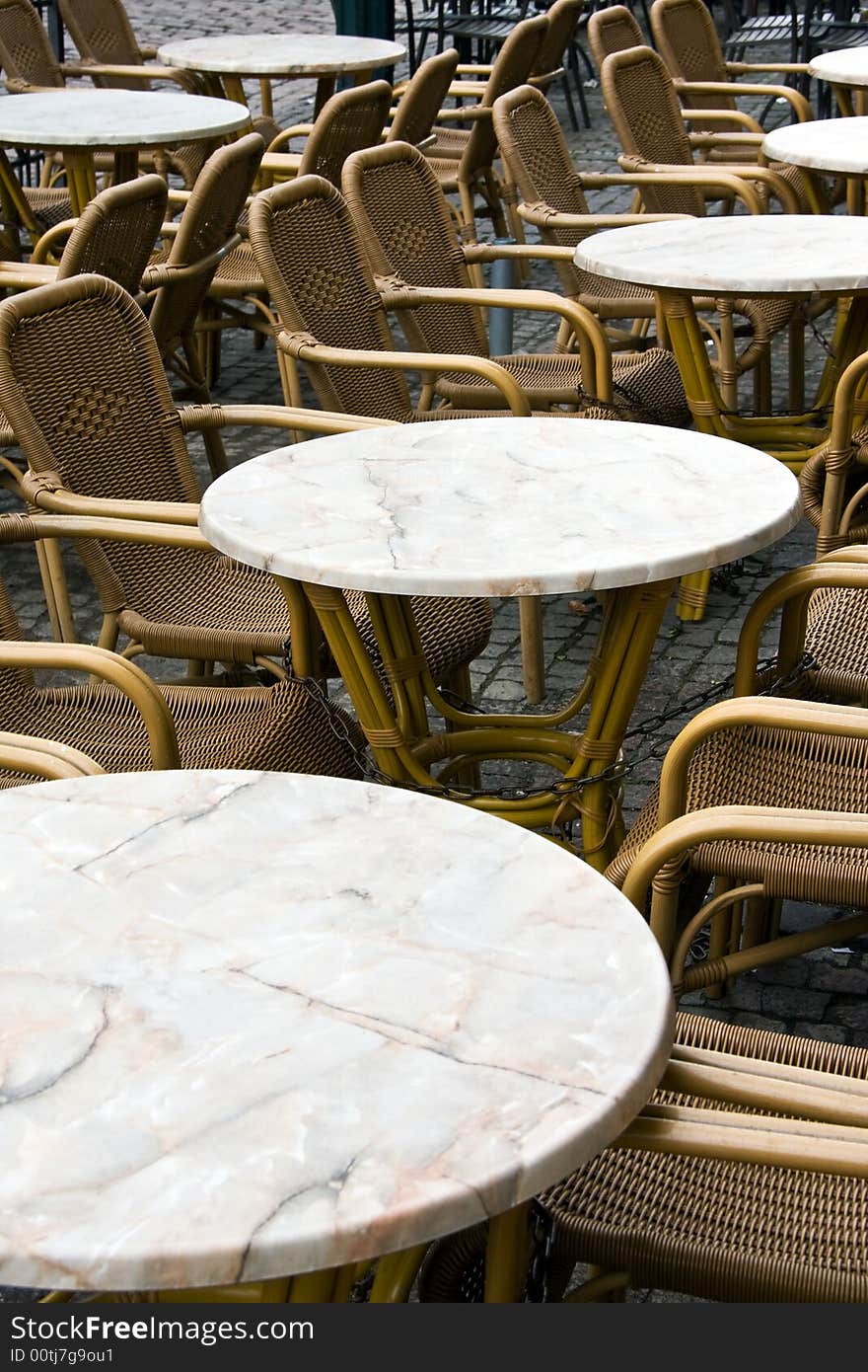 Tables with armchairs: small old-fashioned street cafe