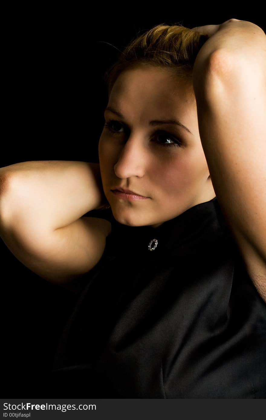 Young woman against a black background