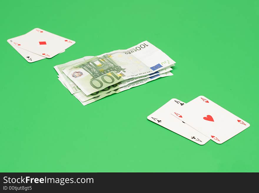 Poker cards vs euro money on green. Poker cards vs euro money on green