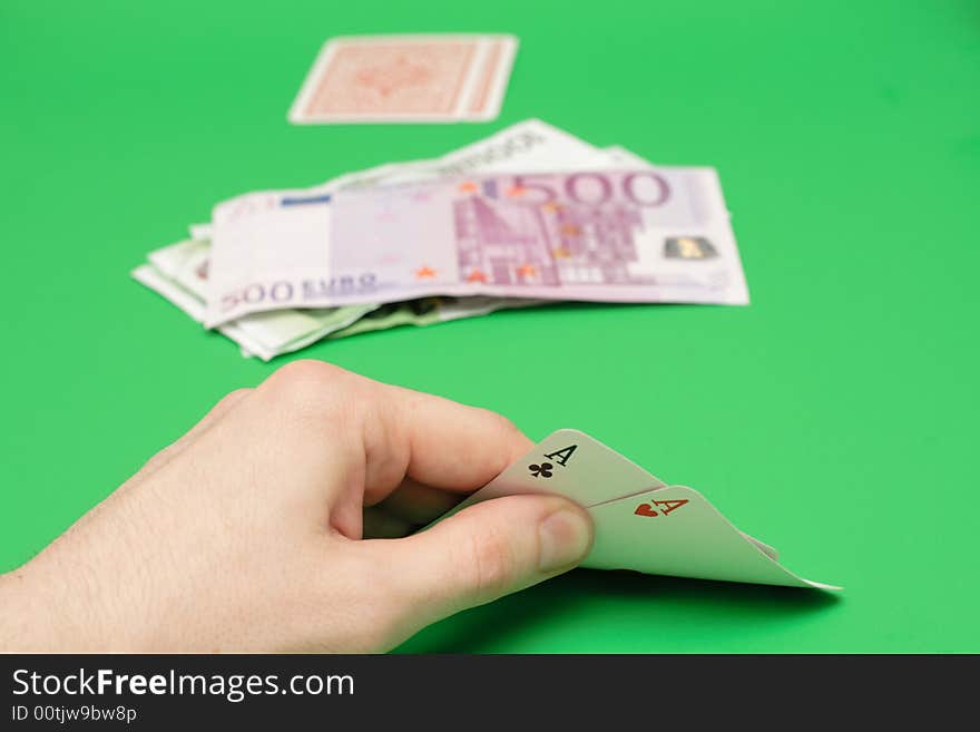 Poker cards vs euro money on green. Poker cards vs euro money on green