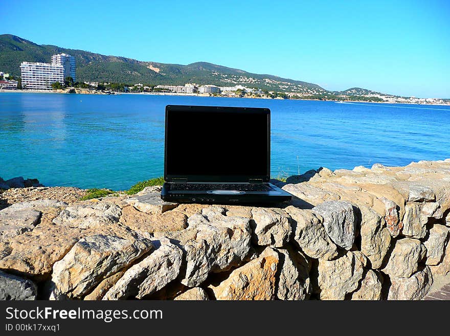 Laptop with sea view and blank screen for text. Laptop with sea view and blank screen for text