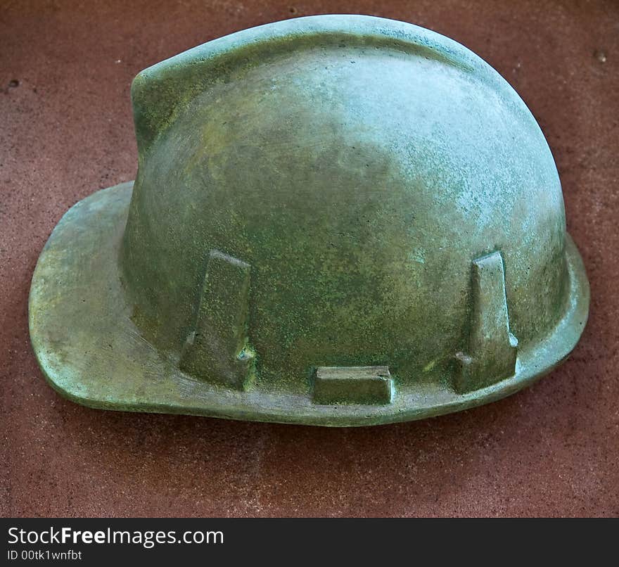 Modern outdoor bronze bas-relief - fireman's helmet. Modern outdoor bronze bas-relief - fireman's helmet