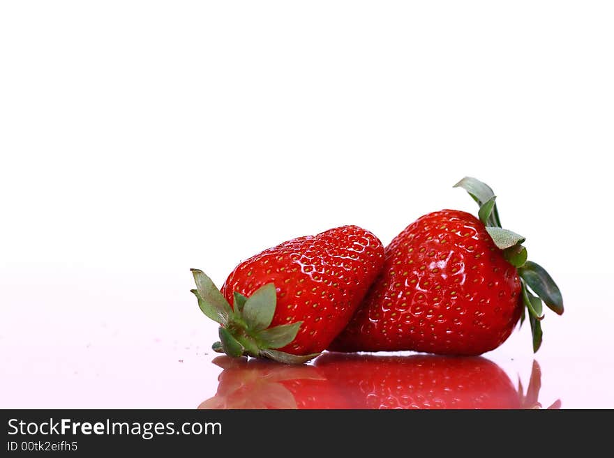 Two strawberries on white background