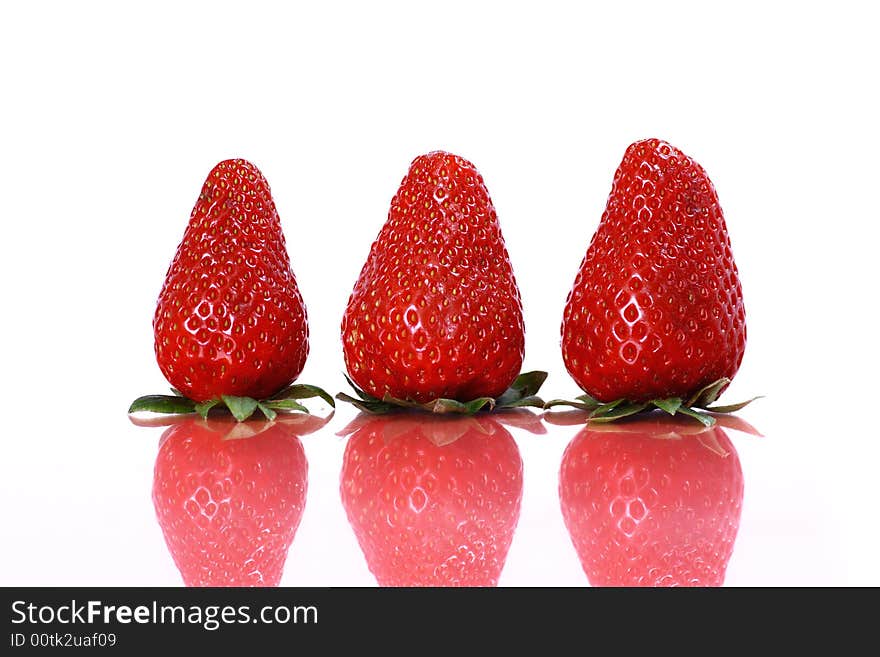 Three strawberries on white background