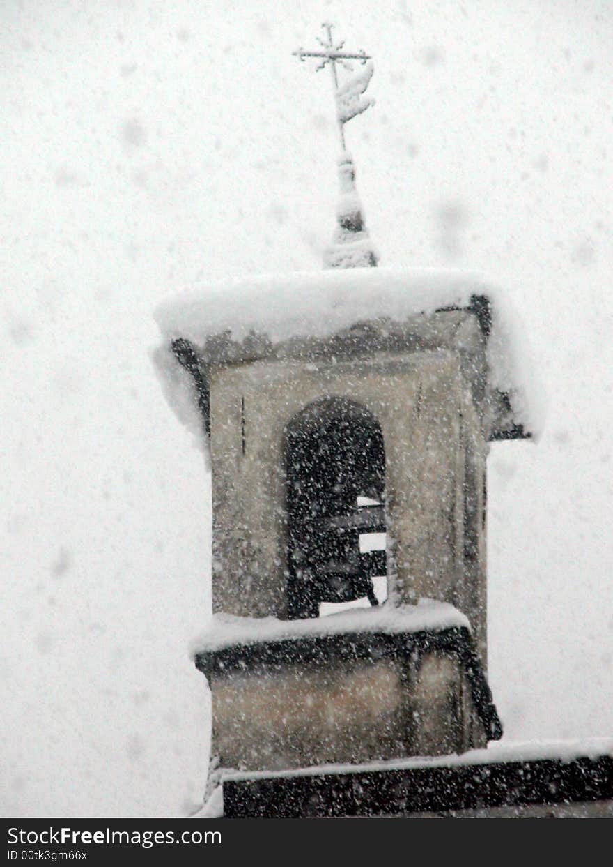 The belltower of the churh of San Sebastiano in Monno, Italy, during  a snow fall in December 2003. The belltower of the churh of San Sebastiano in Monno, Italy, during  a snow fall in December 2003