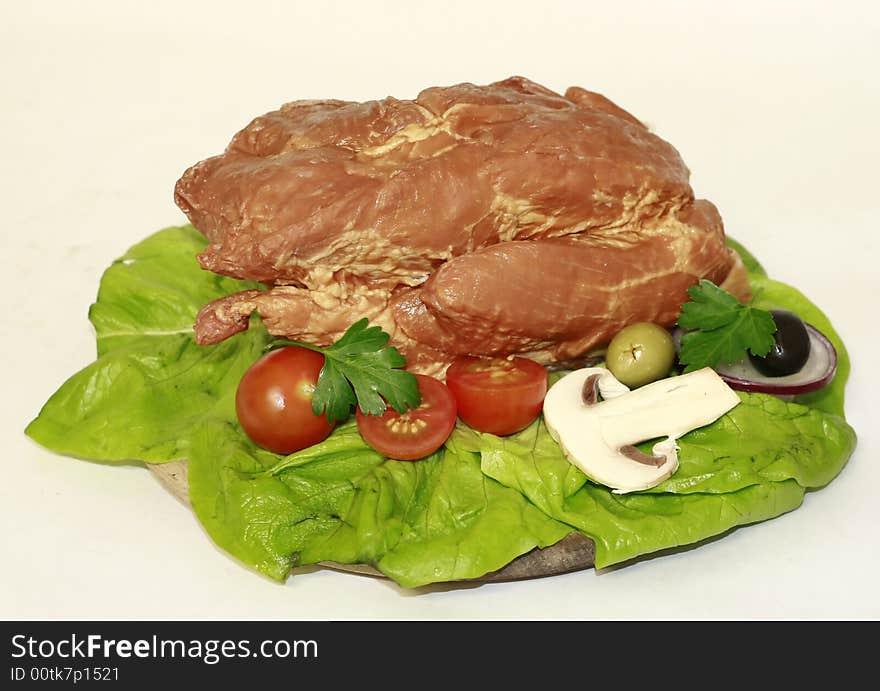 Cooked pork meat with salad and vegetable decoration