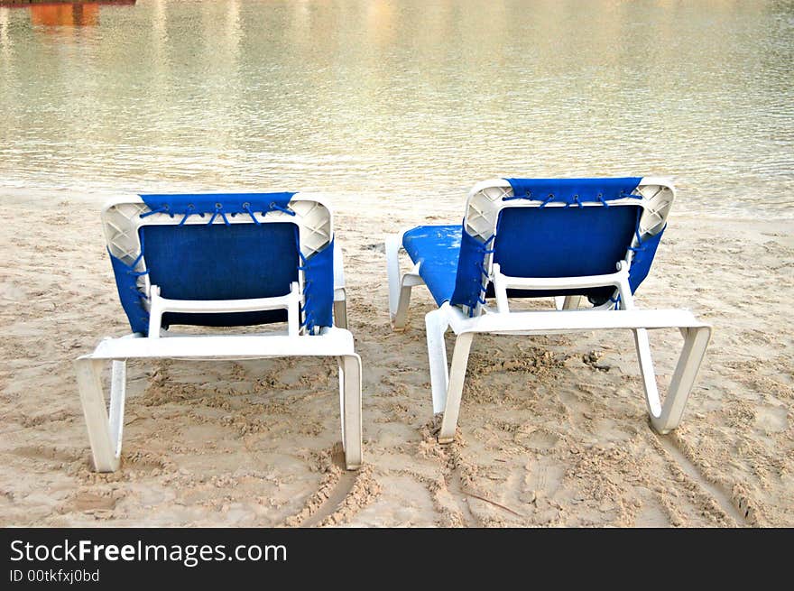 Beach blue chairs in a  cancun beach