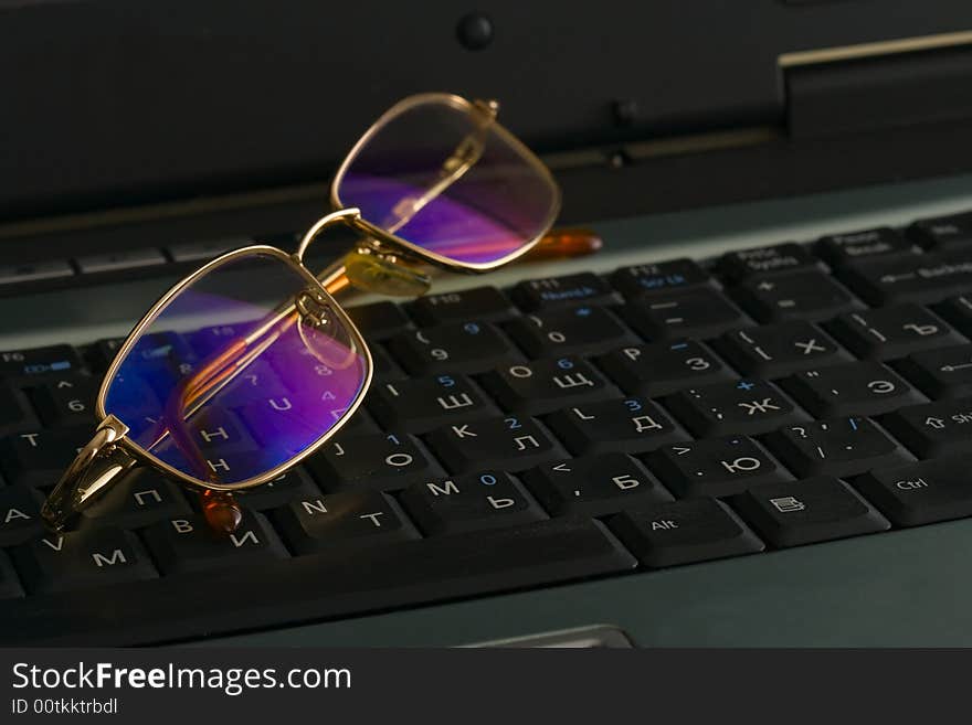 Laptop and laying on glasses. Laptop and laying on glasses