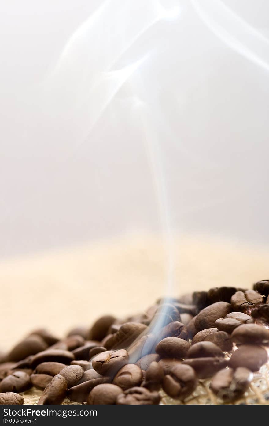 Roasted coffee beans with rising smoke