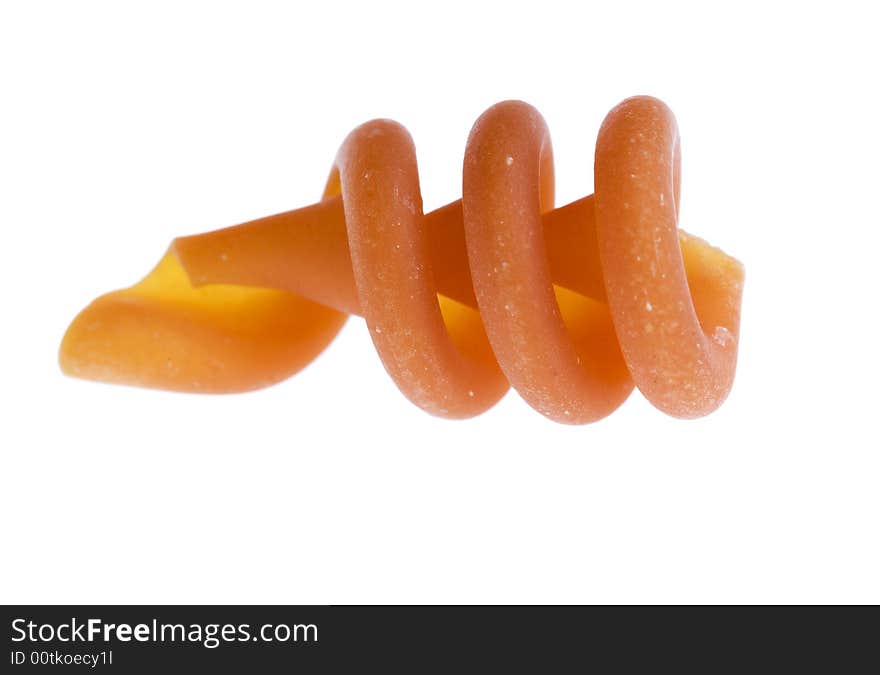 Studio close-up of a single piece of Trottole pasta isolated against white background