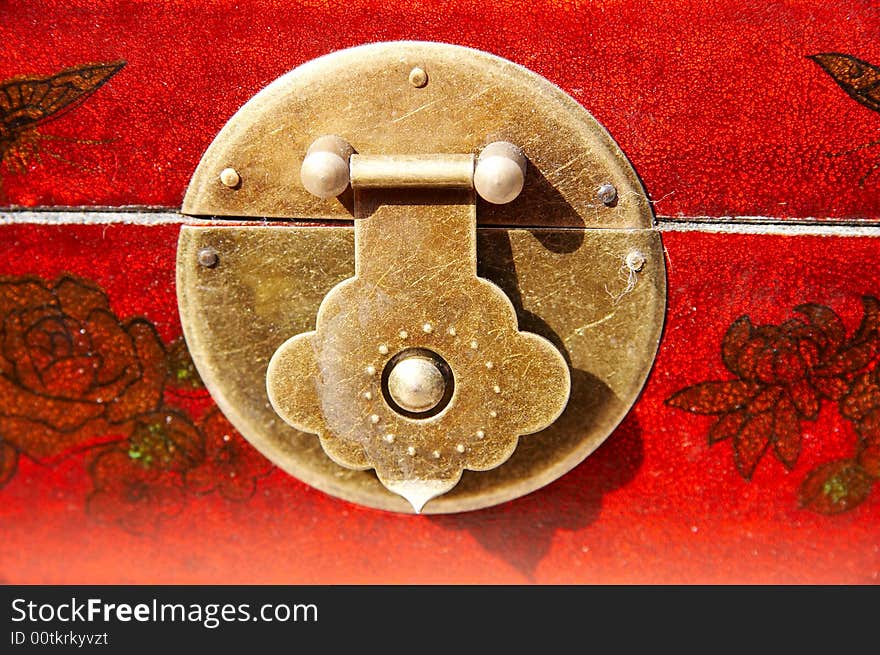 Detail of chinese furniture,round lock on red wooden furniture. Detail of chinese furniture,round lock on red wooden furniture