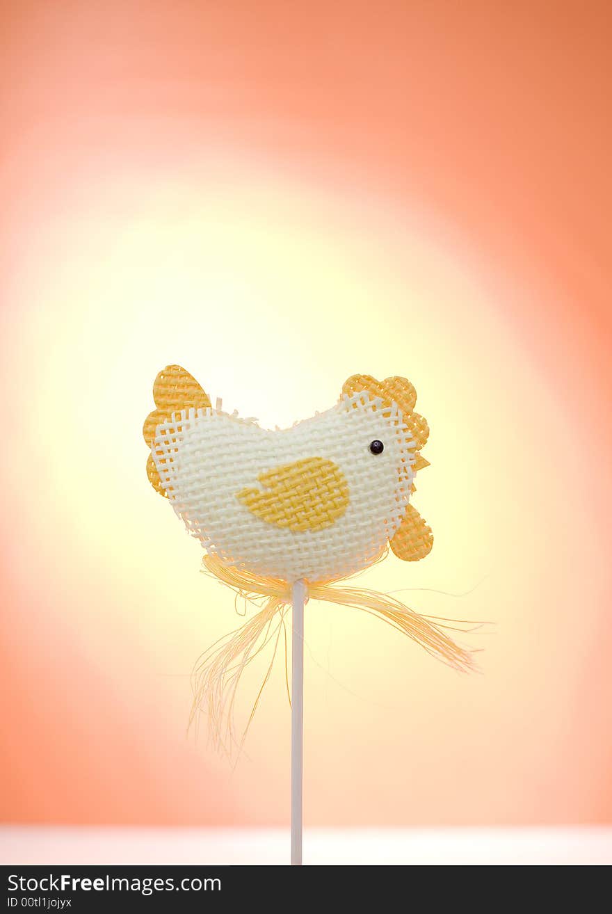 Easter chicken on the orange background / sunshine