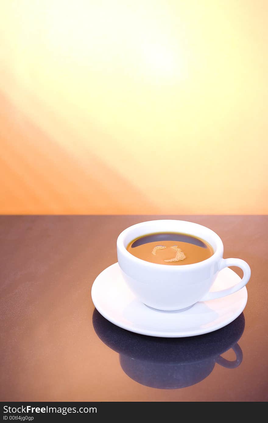 Cup of coffee on the brown background / sunshine