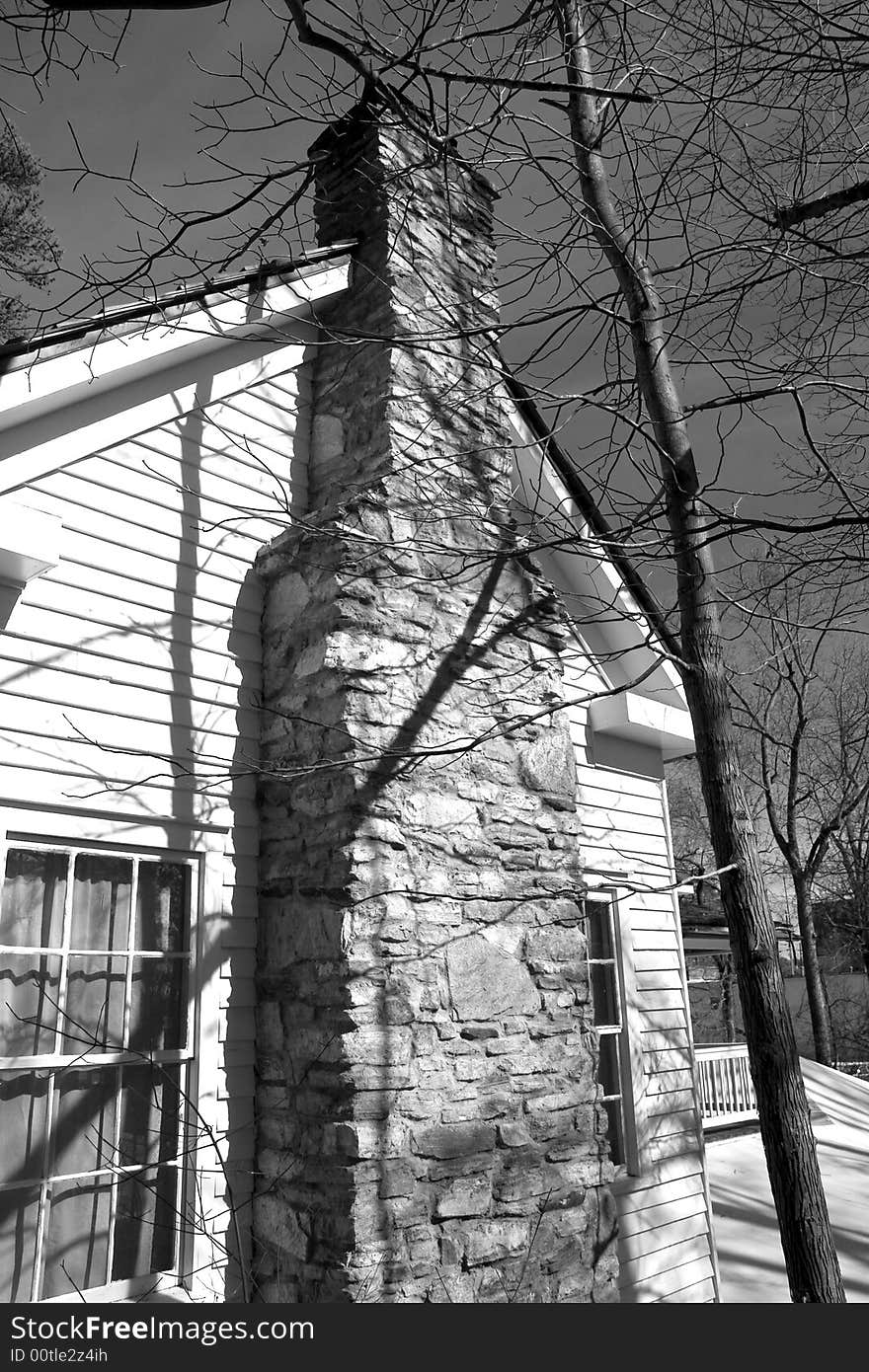 A stone chimney on an old farmhouse in black and white. A stone chimney on an old farmhouse in black and white