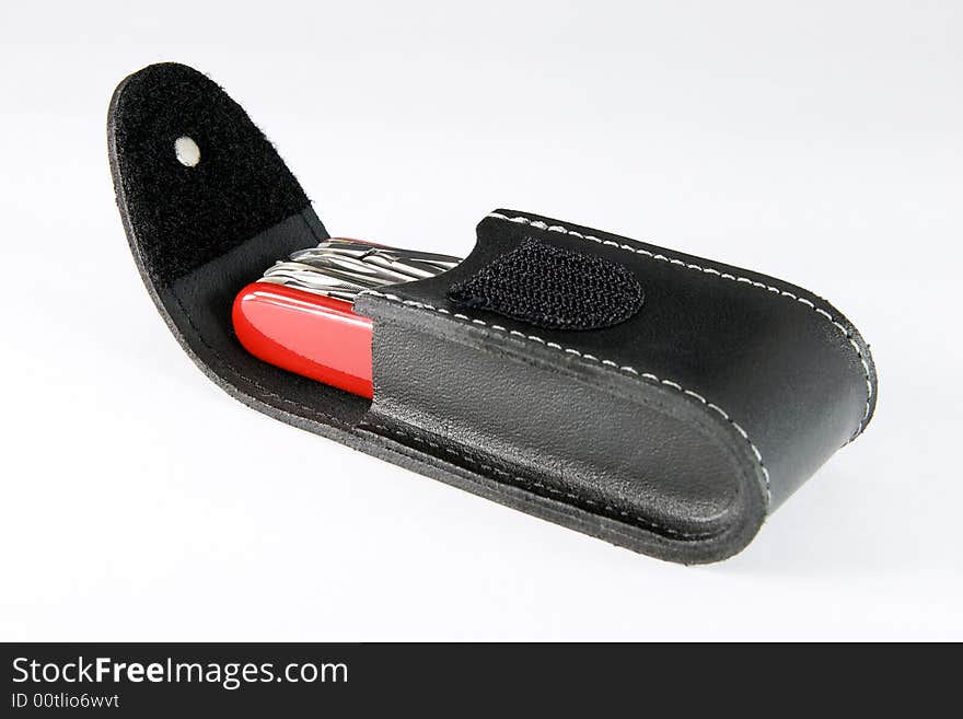 Multifunctional pocket knife in leather pouch on white background