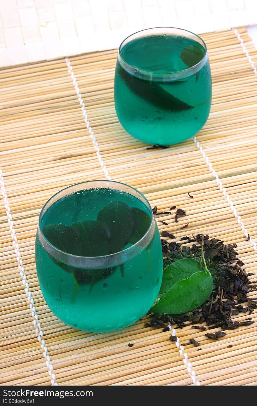 Dry leaves of green tea on white background