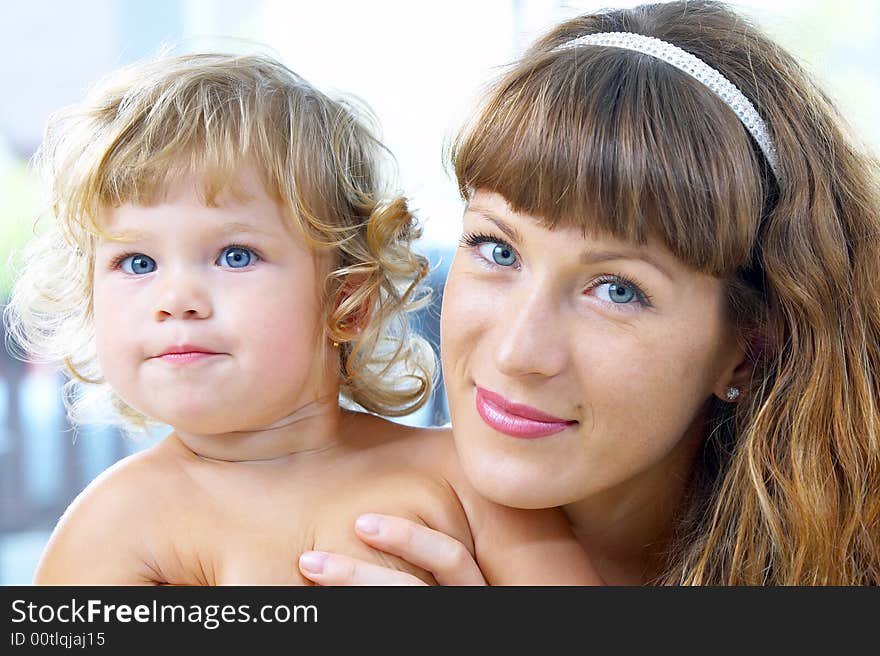 High key portrait of happy mother with baby. High key portrait of happy mother with baby