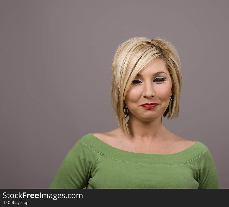 A blonde woman with smiling eyes and lips. A blonde woman with smiling eyes and lips