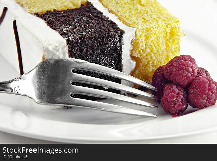 Checkerboard Cake with Raspberries on a white background.