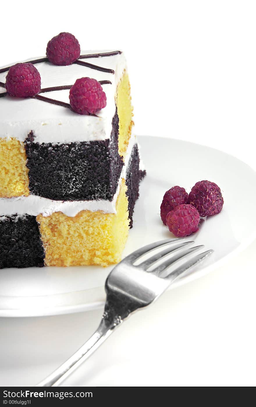 Checkerboard Cake with Raspberries on a white background.