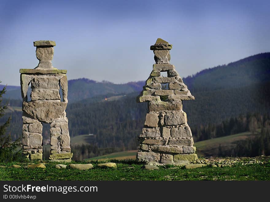 Two stone statues in the high mountains