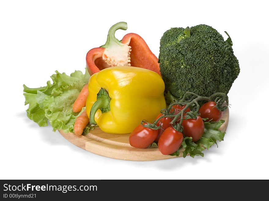 Paprika, small tomatoes, green salad leaves, carrot, cabbage on the kitchen board. Paprika, small tomatoes, green salad leaves, carrot, cabbage on the kitchen board