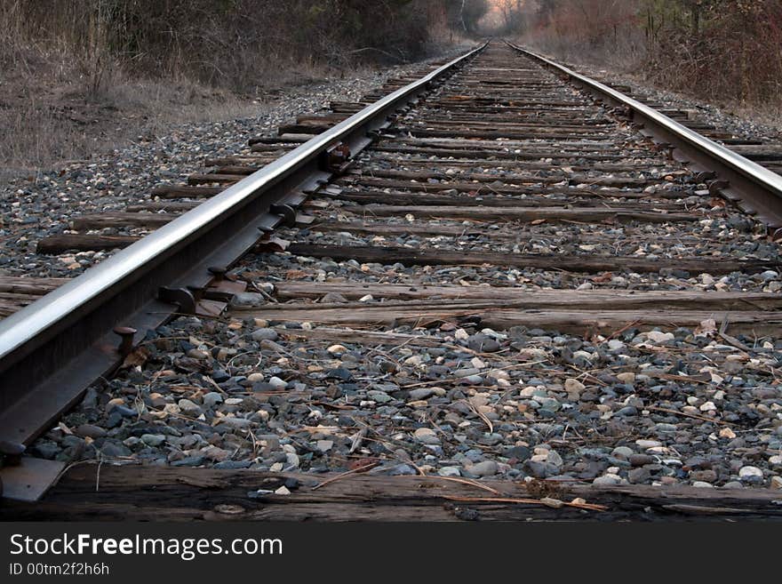 A set of railroad tracks trailing off into the distance.