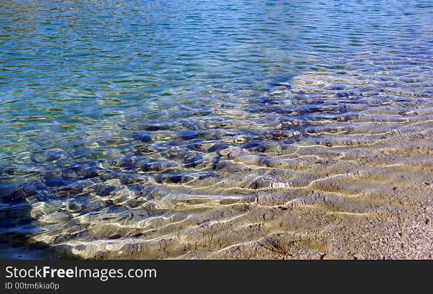 Ripples on the water at the shoreline of the Small Zellersee .Chimgauer Alpes Germany Bavaria. Ripples on the water at the shoreline of the Small Zellersee .Chimgauer Alpes Germany Bavaria