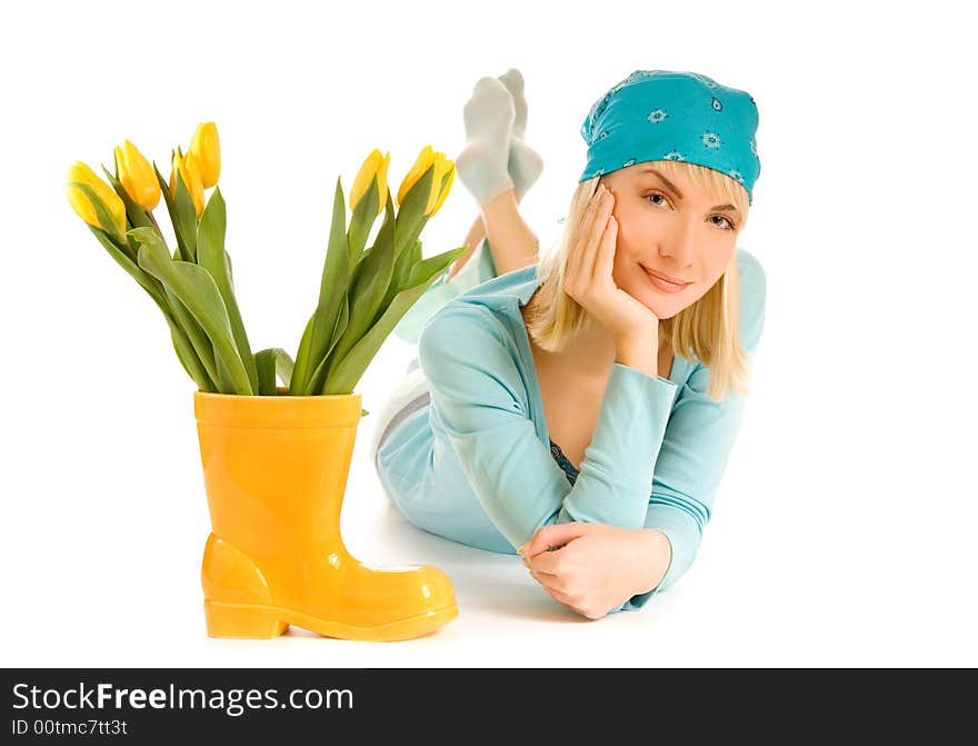 Beautiful teenage girl with yellow tulips isolated on white background