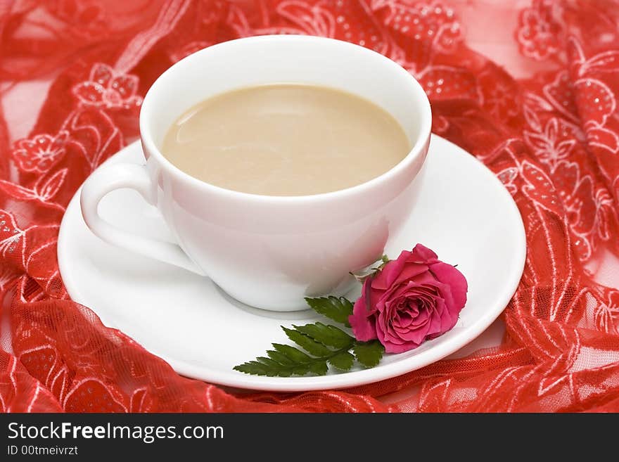 White cup of coffee with red rose