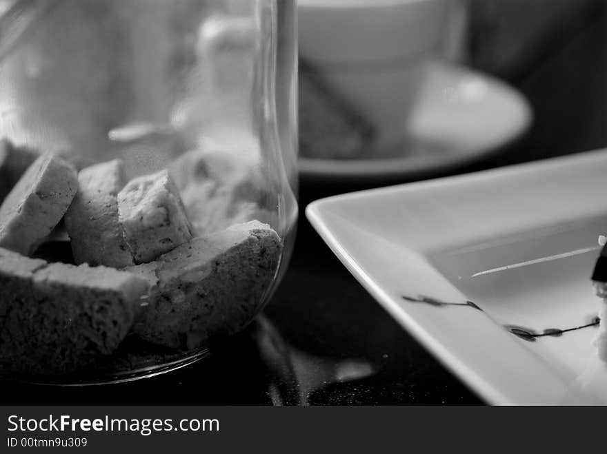 Modern british cafe with espresso, chocolate biscuit, sugar cubes, biscotti and funky crockery. Modern british cafe with espresso, chocolate biscuit, sugar cubes, biscotti and funky crockery