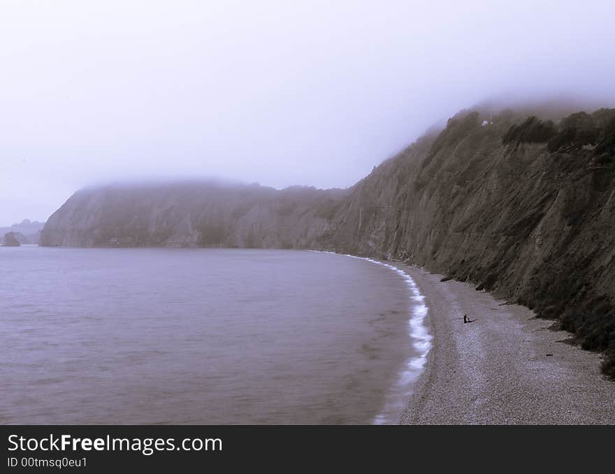 Foggy beach and coastline at Sidmouth in Devon UK. Foggy beach and coastline at Sidmouth in Devon UK