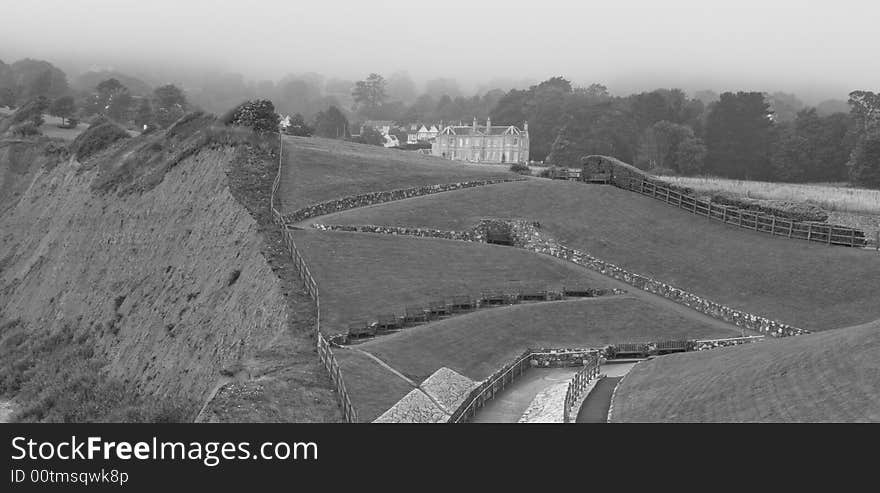 Foggy coastline and fields with manor house at Sidmouth in Devon UK. Foggy coastline and fields with manor house at Sidmouth in Devon UK