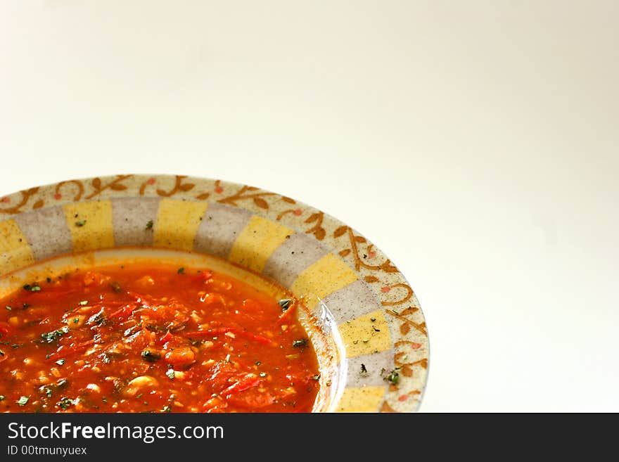 Chunky homemade tomato soup with chopped basil and garlic and a dash of olive oil