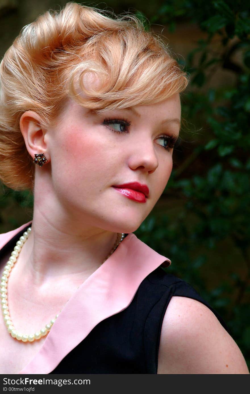 Closeup of young blond woman in pearls