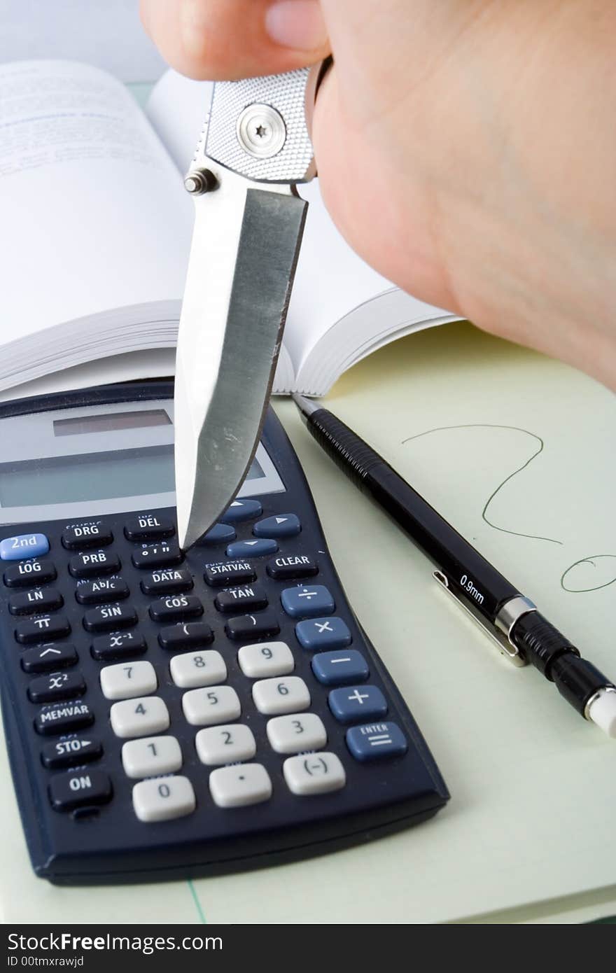 A knife attacking a calculator out of frustration. A knife attacking a calculator out of frustration.