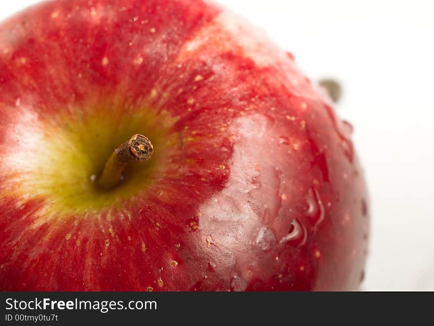 Close up red apple and stem on white isolated background.