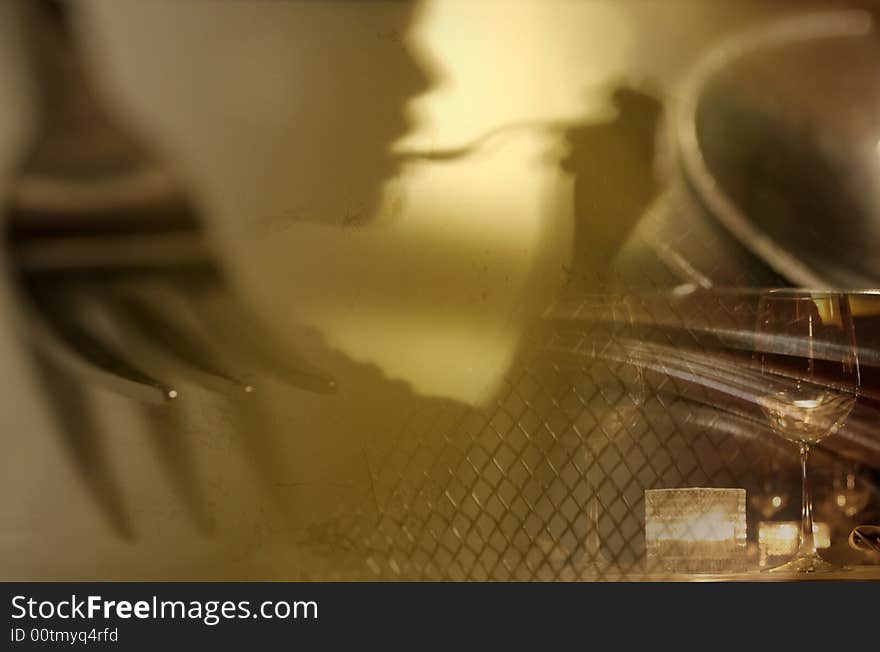 Composite of different food related subjects with shadow of a person with fork in her mouth. Composite of different food related subjects with shadow of a person with fork in her mouth