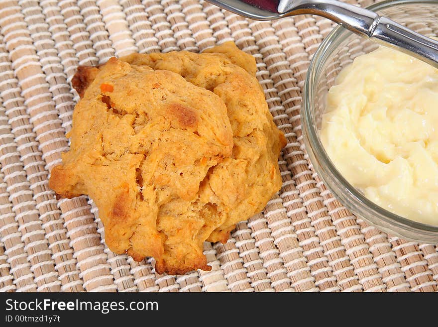 Sweet Potato Biscuit and Butter on wicker place mat.