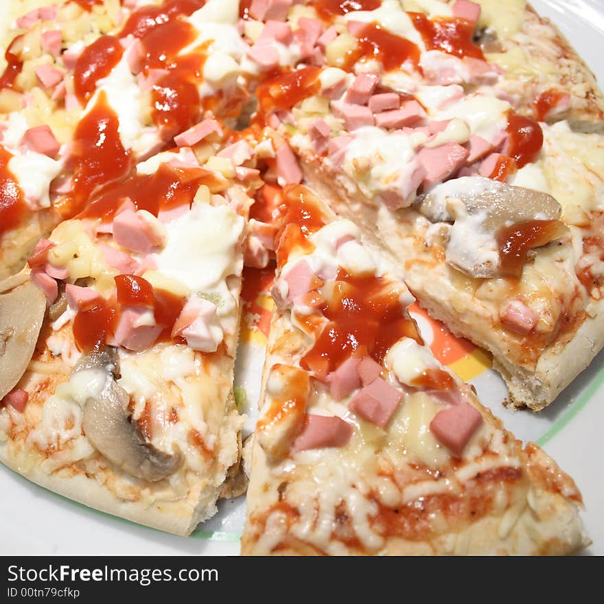 Fresh pizza with mushrooms and sausages on white plate. Fresh pizza with mushrooms and sausages on white plate